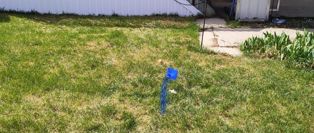 leak marked on the ground with blue paint in front of a mobile home