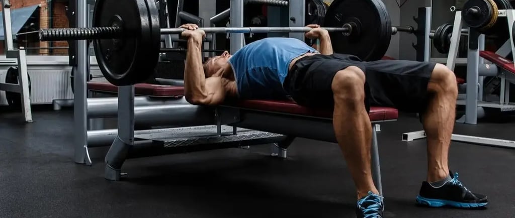 a man is doing a bench press exercise
