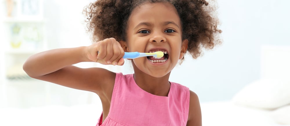 a child brushing teeth 