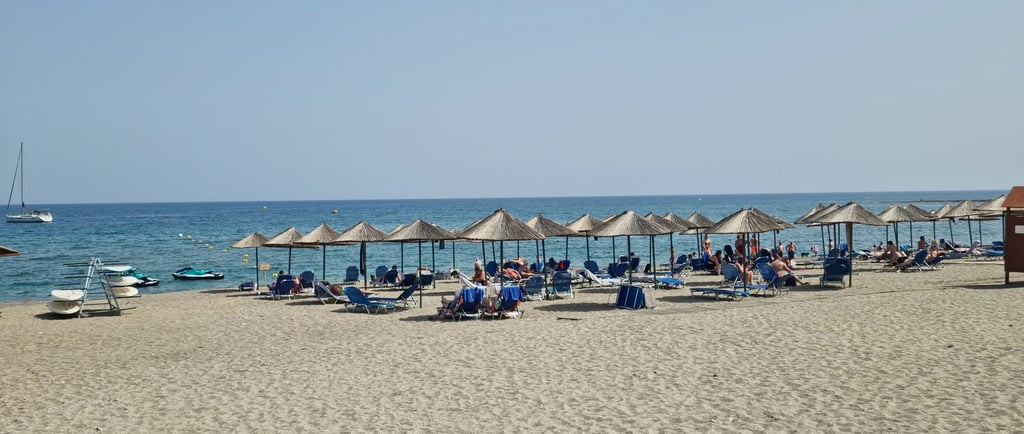 a beach with umbrellas and umbrellas on the sand