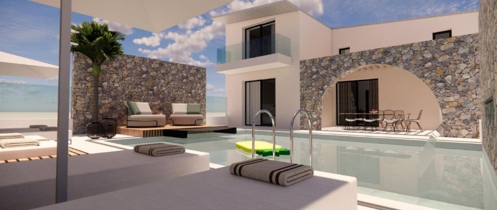Luxury modern villa with private swimming pool, sun loungers, and stone walls under a blue sky.