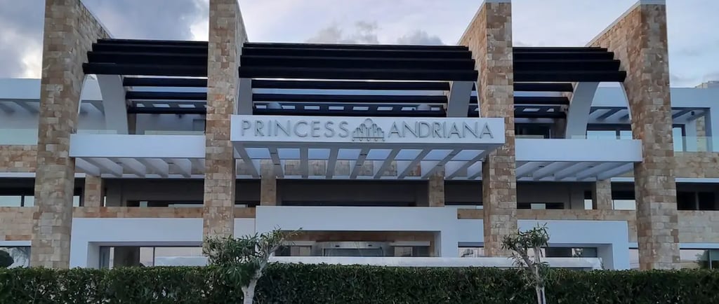 front entrance of princess andriana hotel with hotel sign
