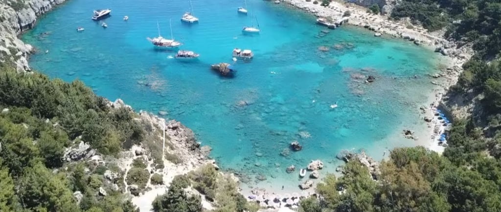 Anthony Quinn Bay Rhodes with emerald water and few boats