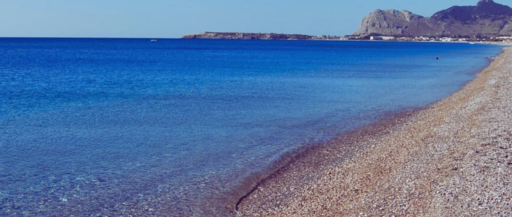 a beach with a boat in the water