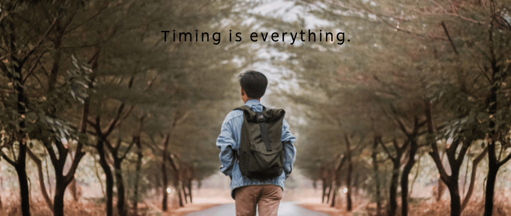 a man walking down a road with a backpack on his back