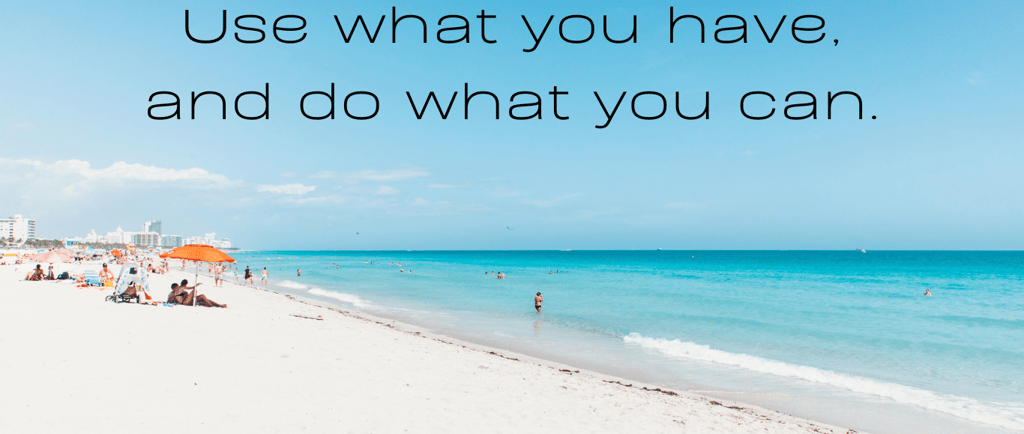 a beach with people sitting on the sand