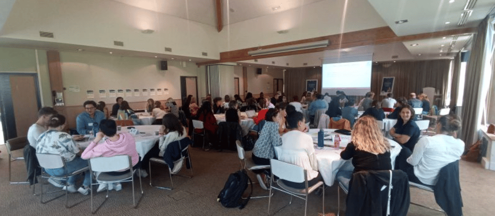 a group of people sitting at tables in a room