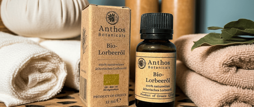 a box and a bottle of bay laurel essential oil sitting on a table