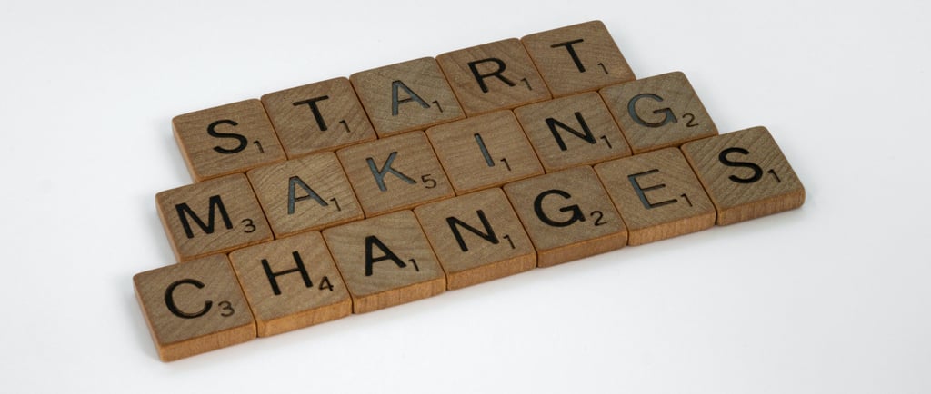 Scrabble tiles spelling out the words start making changes on a white background