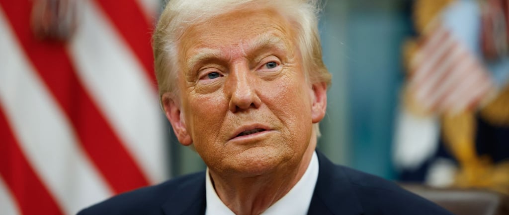 President Trump in a suit and tie with a flag