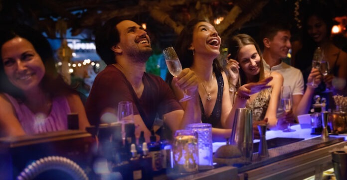 a group of people sitting at a bar