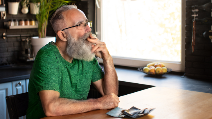 a man with a beard and glasses sitting at a table