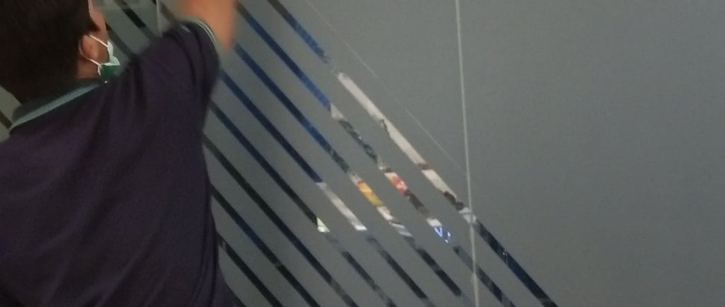 a man standing in a room with a glass door