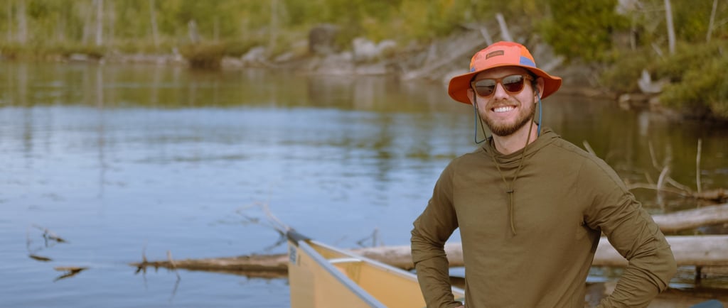 Nate Bowery standing in front of canoe while canoeing the Boundary Waters in Minnesota