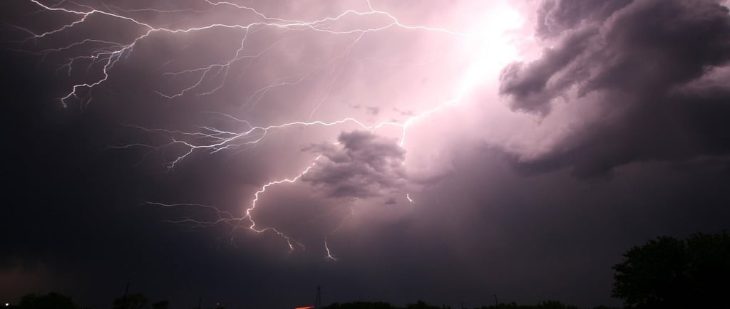 lightning strike high in the storm clouds