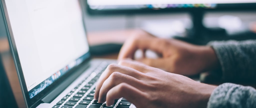 hands on a keyboard of a laptop