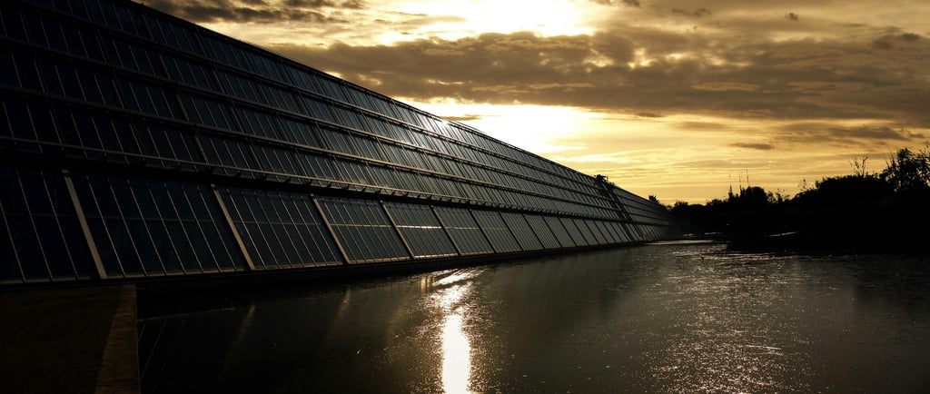 Black Solar Panel Near Calm Body of Water