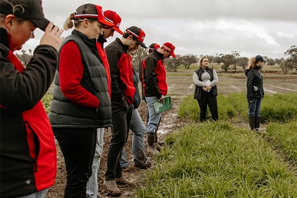 a group of people standing in a field