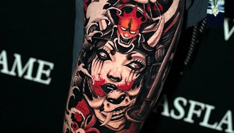 Color Japanese mask tattoo with dramatic red accents