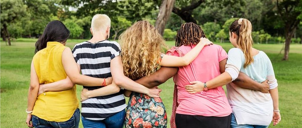 Group of women with their arms around each other