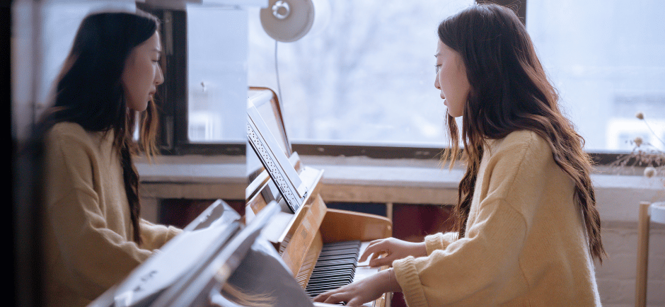 Young Asian woman practicing piano