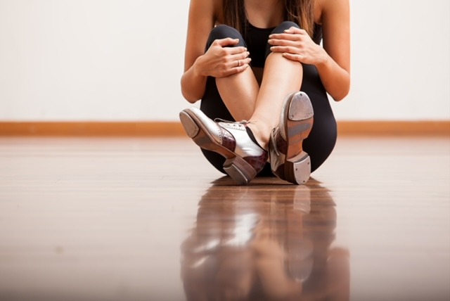 a woman sitting on the floor with her legs crossed