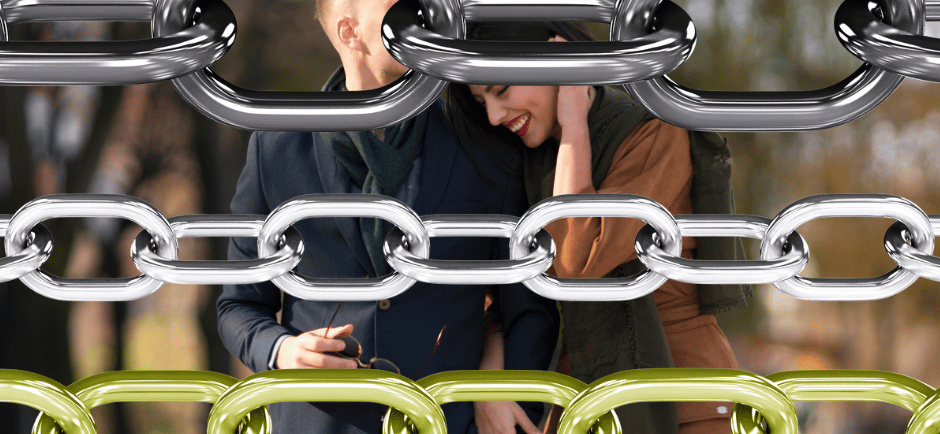 a man and woman standing in front of a chain link link link link link link