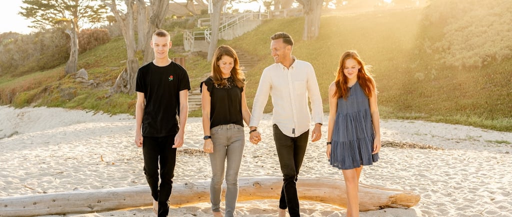 An Empty Nest Family walking on a beach.