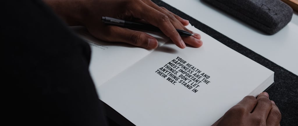 Hand, holding a pen on a page ready to write