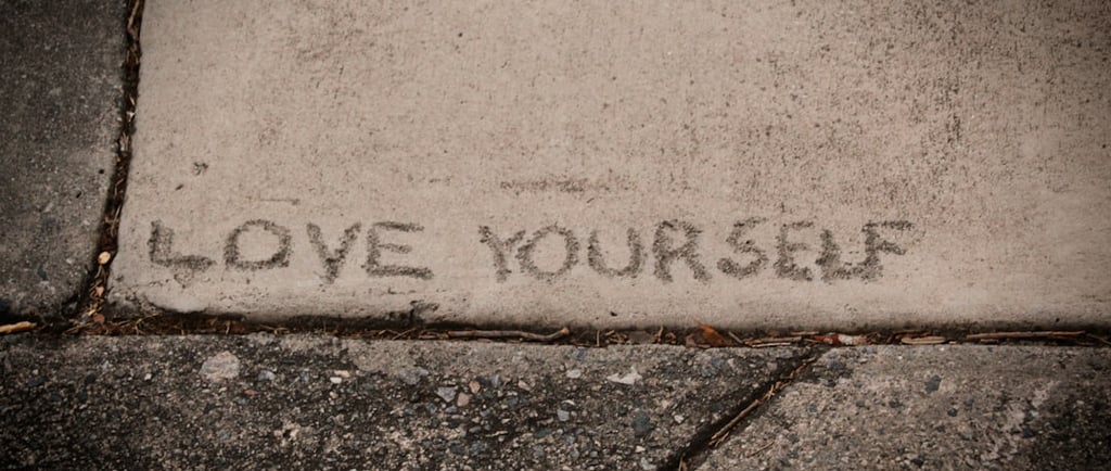 The Words Love Yourself engraved into the pavement