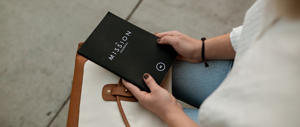 An Empty Nester holding a MISSION Journal