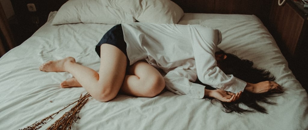 A sad women laid on a bed