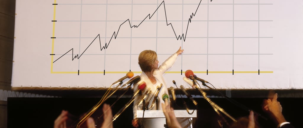 businesswoman pointing at chart representing AI trends 2026