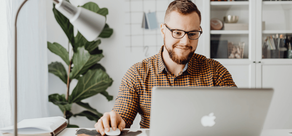 a man sitting at a desk with a laptop computer
