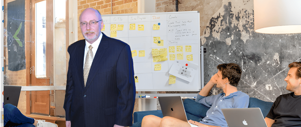 Scott Randy Gerber standing in front of a white board with a group