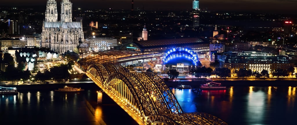 a bridge spanning a river with a cathedral in the background