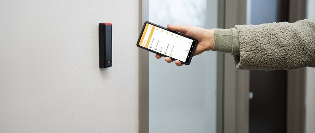 User accessing a secured door using the ProdataKey mobile app with a Bluetooth-enabled reader for cloud-based access control