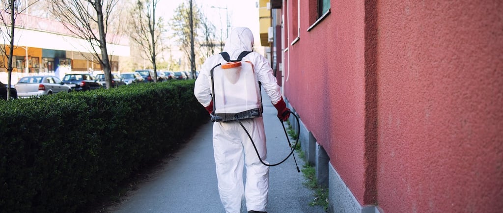 Un professionnel pulvérise une protection à l'extérieur d'un bâtiment.