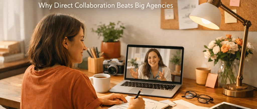 Solo graphic designer working at a desk while collaborating via video call on a laptop.