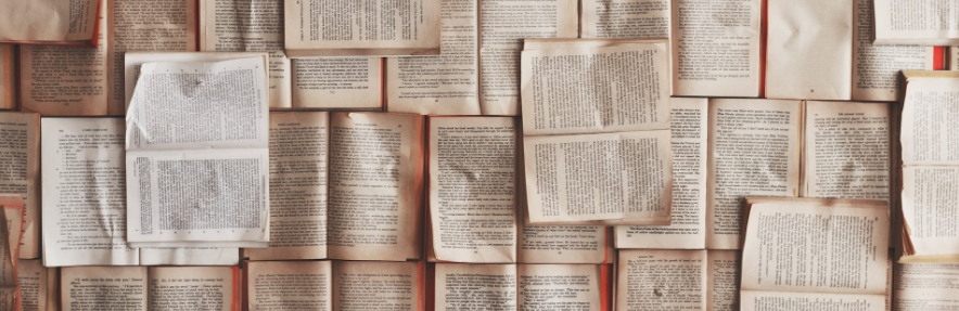 Pile of old used books open to read
