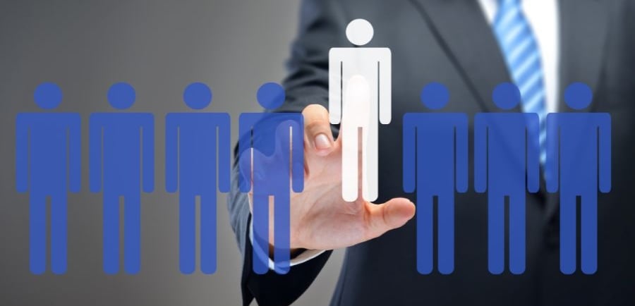 a man in a suit and tie is holding a paper cutout of a person