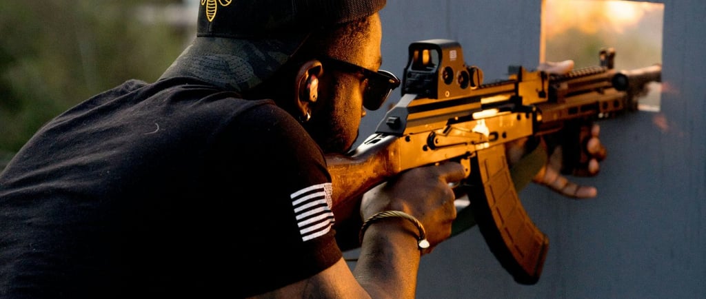 a man is at the range holding a AK 47