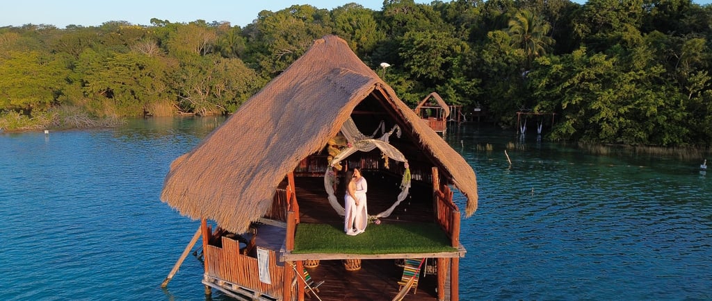 a couple standing on a dock in the water