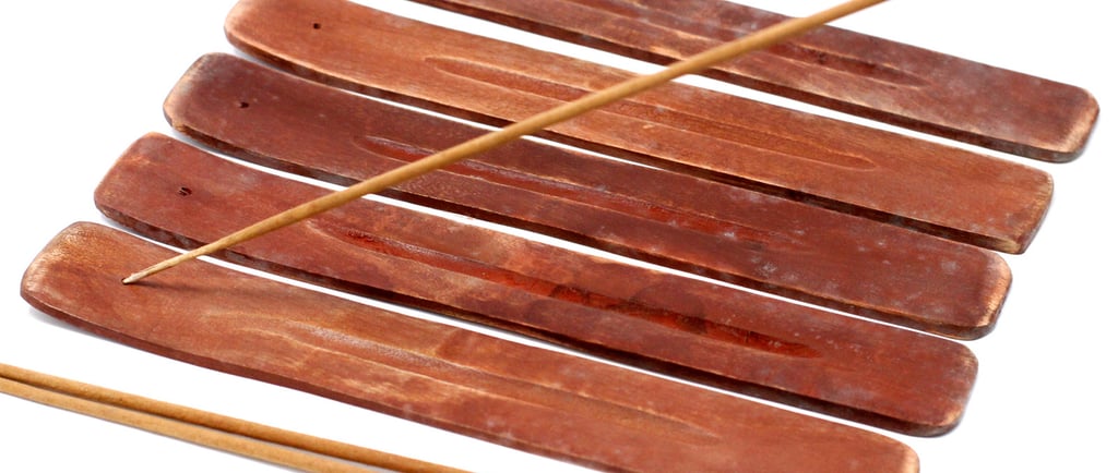 a bunch of sticks sticking out of a wooden sticker