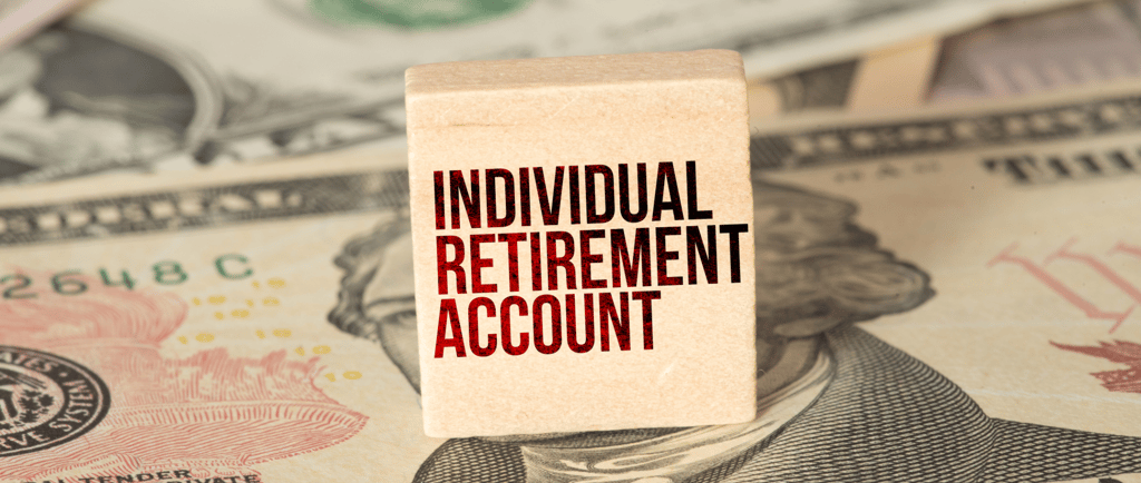 individual retirement account label on a block with money in the background