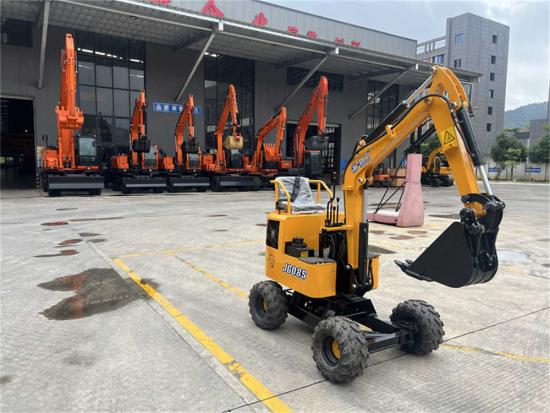 a small excavator with a crane on the back of it