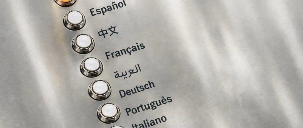A metal control panel with buttons for selecting languages like English, Spanish, and French.