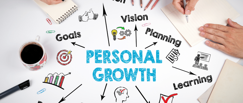a person sitting at a table writing a personal growth plan