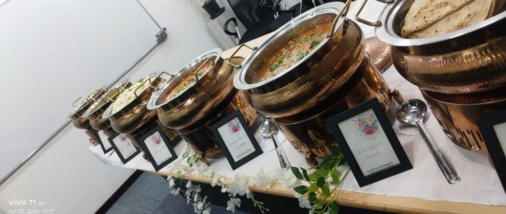 Corporate bufet catering service featuring copper chafing dishes with chicken handi,