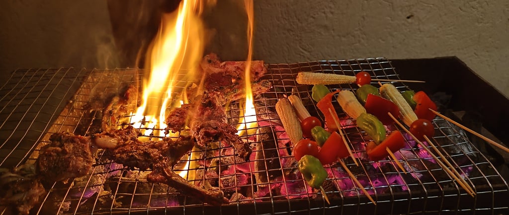 a grill with meat and vegetables on a grill